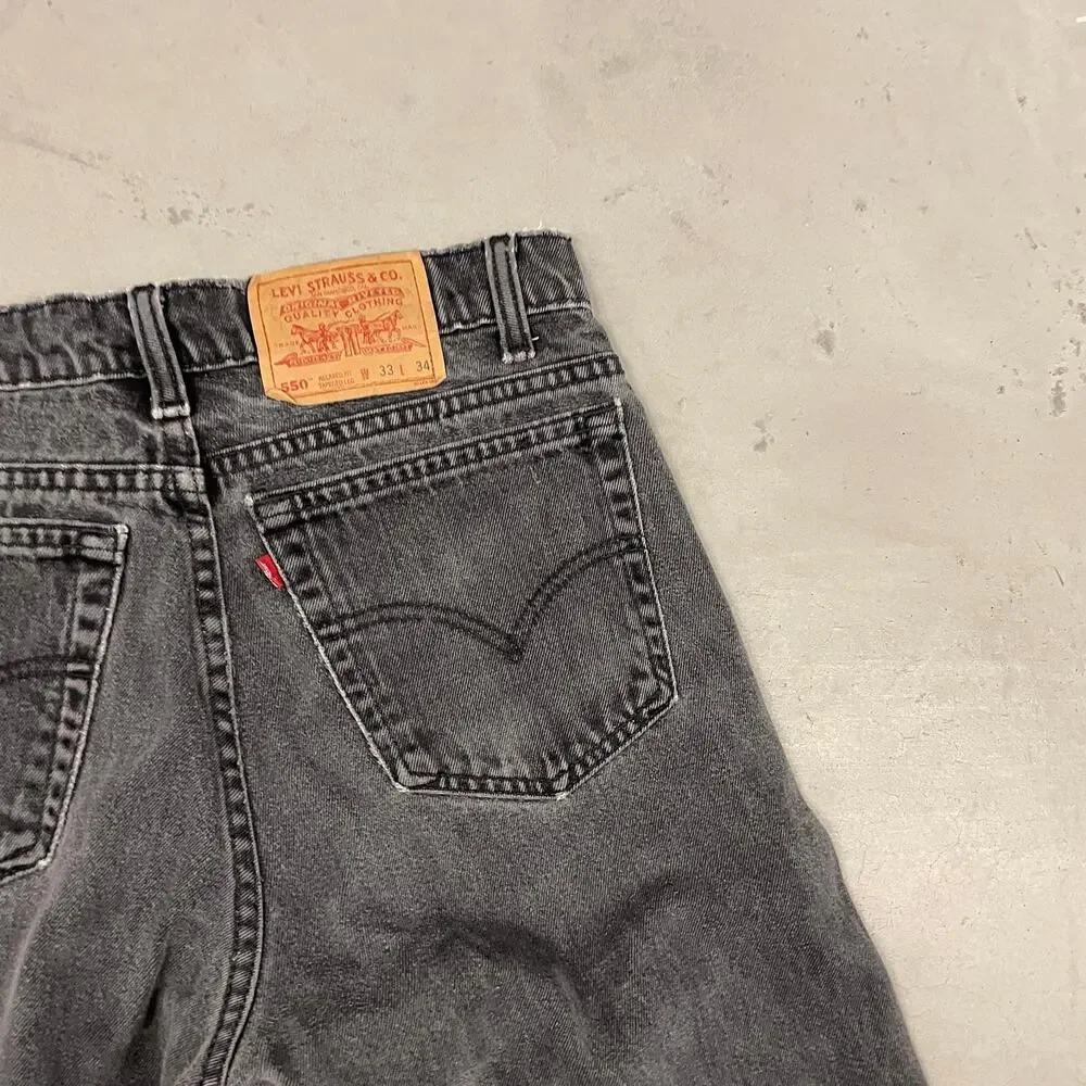 90s faded black Levi’s 550 paper tab jeans 32x33